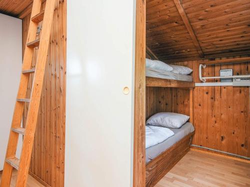 a room with two bunk beds and a ladder at 4 person holiday home in Hampen in Hampen