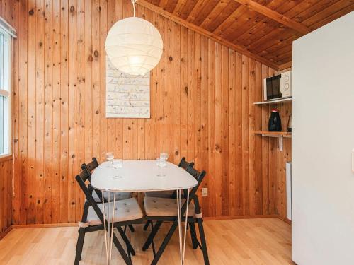 a dining room with a white table and chairs at 4 person holiday home in Hampen in Hampen