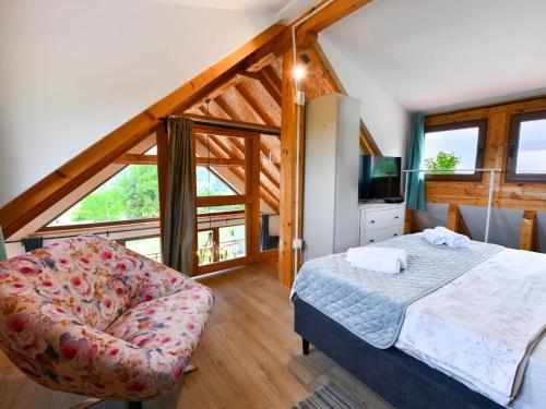 una camera da letto con un letto e una sedia di Plivanje u zalazak sunca - Three Bedroom House a Duga Resa