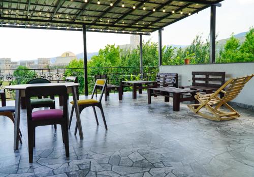 a group of tables and chairs on a patio at NISS House in Akhaltsikhe