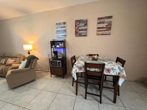 a dining room with a table and a couch at The Casita in San Luis Río Colorado