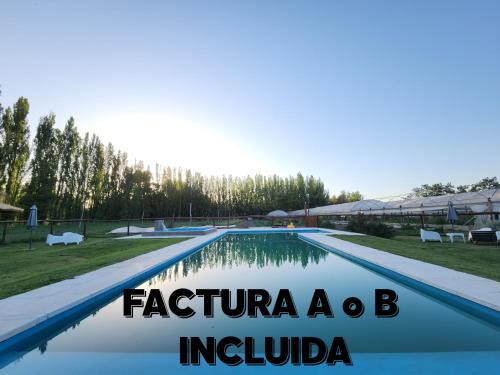 a large swimming pool with the words ferturiosa bc indivo at Casa de Campo Flor Dorada in Centenario