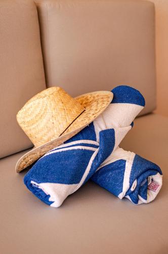 a hat and towels sitting on top of a couch at Casa Lu Hotel Boutique in Mazunte