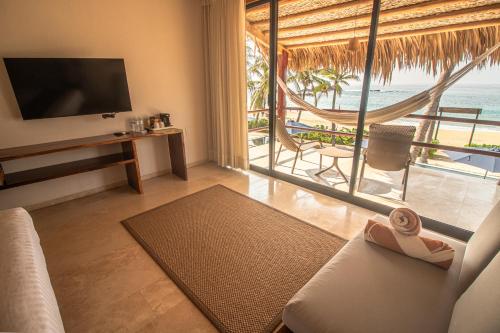 a living room with a view of the ocean at Casa Lu Hotel Boutique in Mazunte