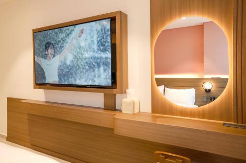 a flat screen tv sitting on a table in a room at Hotelaround Sokcho in Sokcho