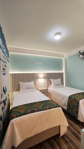 a hotel room with two beds in a room at Mamre Guest House Tacna - Hospedaje in Tacna