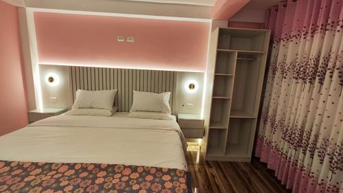 a bedroom with a bed and a book shelf at Mamre Guest House Tacna - Hospedaje in Tacna