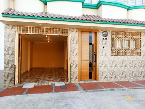 a entrance to a building with a brown door at Mamre Guest House Tacna - Hospedaje in Tacna