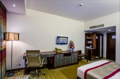 a bedroom with a desk and a bed and a desk at Bengal Blueberry in Dhaka
