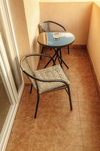 a table and two chairs and a table and a table at Apartmani Sloboda in Belgrade