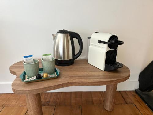 a coffee maker and a toaster on a wooden table at Villa La Renaissance - Etretat in Étretat
