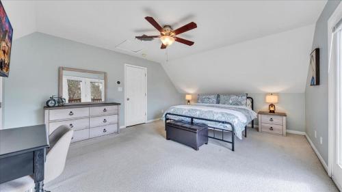 a bedroom with a bed and a ceiling fan at Lakefront 3BR with Dock, Fire Pit, Lawn Games, and Game Room in Moneta