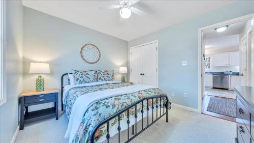 a bedroom with a bed and a table and a kitchen at Lakefront 3BR with Dock, Fire Pit, Lawn Games, and Game Room in Moneta