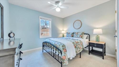 a bedroom with a bed and a ceiling fan at Lakefront 3BR with Dock, Fire Pit, Lawn Games, and Game Room in Moneta