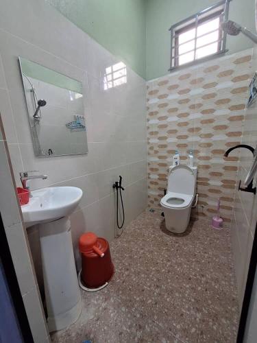 a bathroom with a sink and a toilet at Homestay Kamilia in Bachok