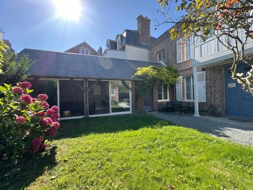 a house with a patio and a yard at Villa La Renaissance - Etretat in Étretat
