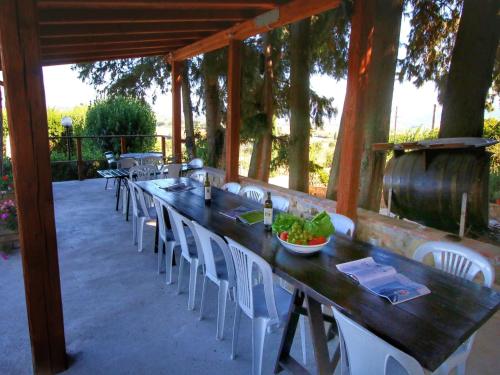 a patio with a table and chairs and a barrel at Farmhouse with Pool – Pets Welcome! in Gualdo Cattaneo