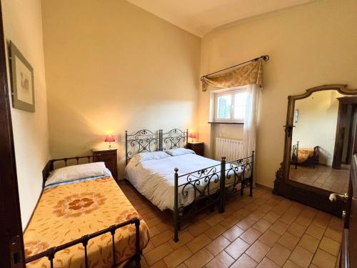 a bedroom with two beds and a mirror at Apartment in Umbria near Vineyards in Giano dellʼUmbria