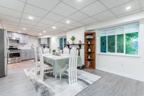 a kitchen with a table and chairs in a room at Spacious Creekside Family Home in North Van in North Vancouver