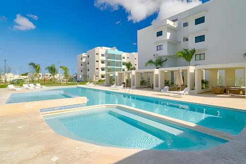 an empty swimming pool in front of a building at Charming 1Bdrm Apt. 10mins from Punta Cana Beaches in Punta Cana