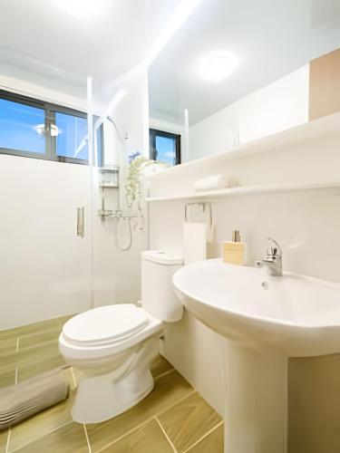 a white bathroom with a toilet and a sink at Charming 1Bdrm Apt. 10mins from Punta Cana Beaches in Punta Cana
