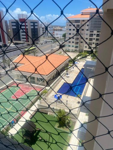 a view of a soccer field from a chain link fence at Apt Luar do Sertao in Aracaju