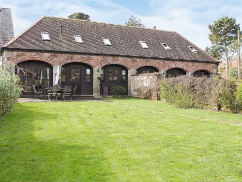 a brick house with a lawn in front of it at Swallow Cottage in Shanklin
