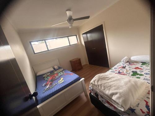 a small bedroom with a bed and a window at Holiday Home in Branxton