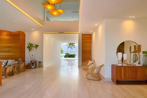 a living room with a table and a mirror at Caribbean Sunscape Beachfront Apartment in La Puntica de Juan Dolio