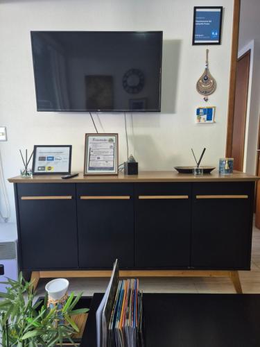 a living room with a large television on a wall at Departamento full equipado Pucón - Casa Ayun in Pucón