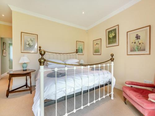 a bedroom with a white bed and a red couch at The Fishing Lodge in Amesbury