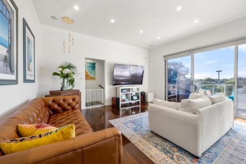 a living room with a couch and a tv at Epic Rye Penthouse with Bubble Dome & Amazing Views! in Rye