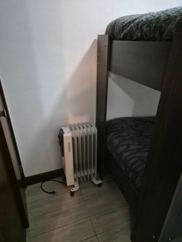 a bunk bed with a radiator in a room at Departamento full equipado Pucón - Casa Ayun in Pucón