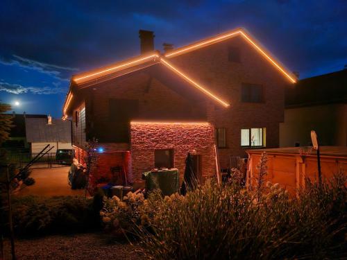 a house with lights on top of it at night at Wellness Toliar Tatry in Stará Lesná