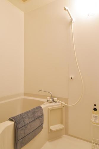 a bathroom with a bathtub with a shower at Kamakura Jomyoji Terrace-鎌倉浄明寺テラス- in Kamakura
