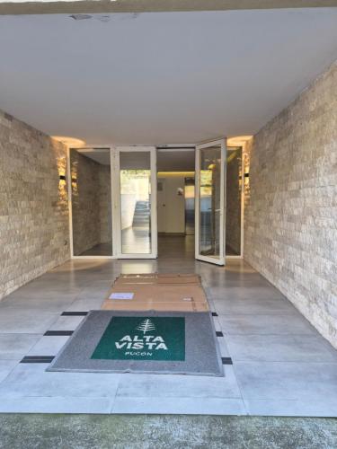 an entrance to a building with a sign on the floor at Departamento full equipado Pucón - Casa Ayun in Pucón
