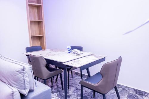 a dining room with a table and chairs at Hilton Palace Hotel in Kano