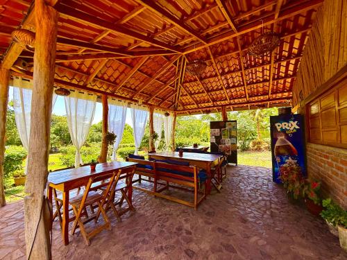 a pavilion with tables and chairs on a patio at Finca Montaña Sagrada in Mérida
