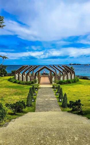 a walkway leading to a building with a view of the ocean at Mactan Newtown Seaview Condo by Cebu Pigmom in Punta Engaño
