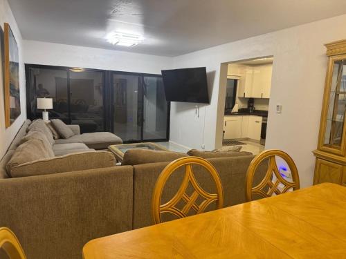 a living room with a couch and a table at Playa Del Pedro Beach House in Guam