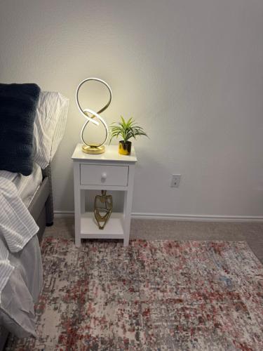 a nightstand with a heart on it next to a bed at Lakemeadow in Princeton