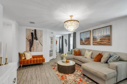 a living room with a couch and a chandelier at Lakemeadow in Princeton
