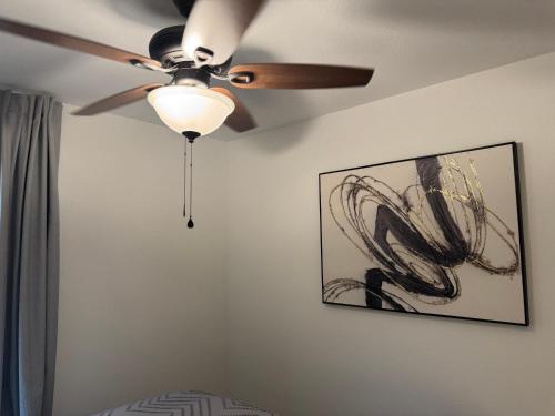a ceiling fan hanging on a wall with a picture at Lakemeadow in Princeton