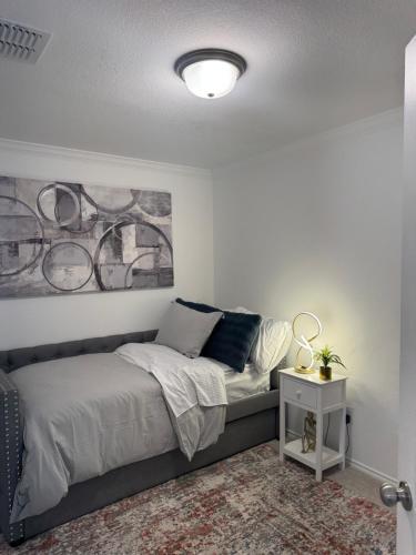 a bedroom with a bed and a painting on the wall at Lakemeadow in Princeton