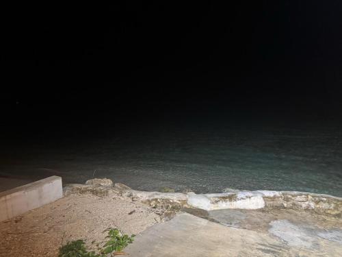 a view of the ocean at night at Playa Del Pedro Beach House in Guam