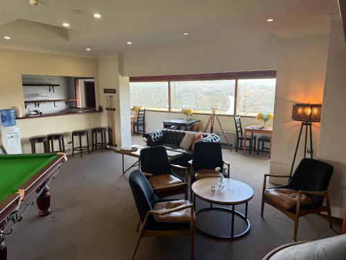 a living room with a pool table and a room with a pool table at Eagle View Escape in Rydal