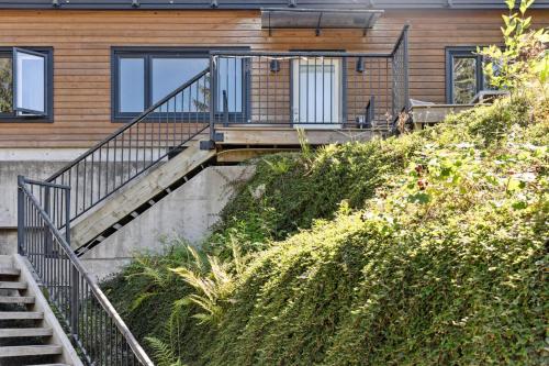 a house with stairs leading up to a house at Forest Retreat with Terrace near Horseshoe Bay Ferry and Marina in West Vancouver