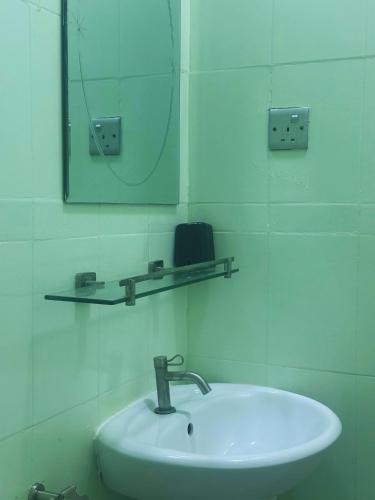 a bathroom with a sink and a mirror at Bahaaru Villa Surf and Stay in Himmafushi