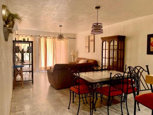 a living room with a table and a couch at Villa en Marinaterra en seguida de Marina San Carlos in San Carlos
