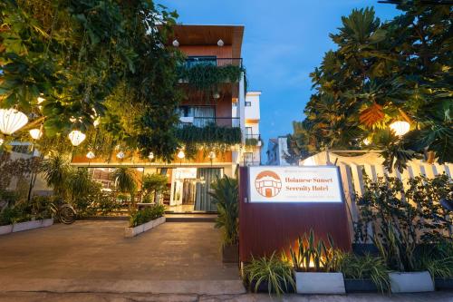 a sign in front of a building with trees at Hoianese Sunset Serenity Hotel in Hoi An